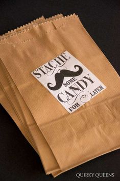 three brown paper bags are stacked on top of each other, one with a mustache and the other has an ad for candy