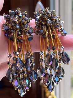 Stunning and unique very long designer clip on earrings. Signed Lois Ann-they measure 3.5 inches. Featuring faceted purple crystal beads everywhere and dangling below each are 8 long fringes each with more faceted crystals at the end. The purple stones all have an Aurora Borealis effect to them. There is some slight tarnish to the backs-but they are ready to wear and wow. They look much better in person. Faceted Crystal Earrings For Party, Unique Dangle Clip-on Earrings For Party, Luxury Purple Cluster Jewelry, Luxury Elegant Gemstone Clip-on Earrings, Elegant Purple Clip-on Earrings, Elegant Handmade Purple Clip-on Earrings, Vintage Evening Clip-on Crystal Earrings, Long Fringes, Purple Stones