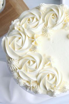 homemade almond buttercream frosting on a white cake with the words homemade almond buttercream