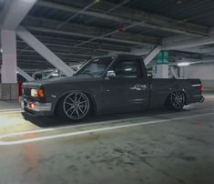 a black truck parked in a parking garage