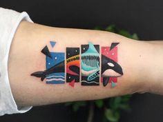 a person with a tattoo on their arm that has an orca whale in it