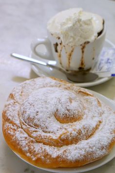 two plates with pastries on them next to a cup of ice cream