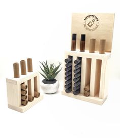 an assortment of wine bottles in wooden crates and a succulent on a white background