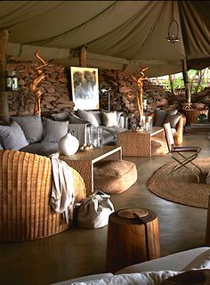 a living room filled with lots of furniture under a tent