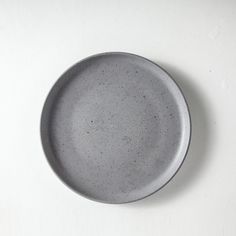 a gray plate sitting on top of a white table