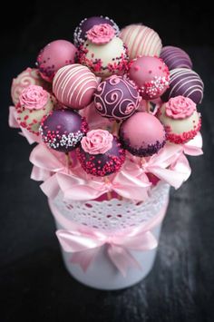 a vase filled with lots of pink and white chocolates