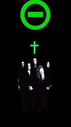 a group of people standing next to each other in front of a green cross on a black background