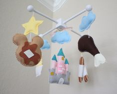 three baby mobiles hanging from the ceiling in a child's room with castle and stars on them