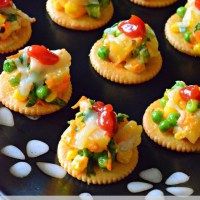 small crackers with various types of food on them and the words biscuit canapes written below