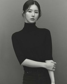 black and white photograph of a woman with her arms crossed