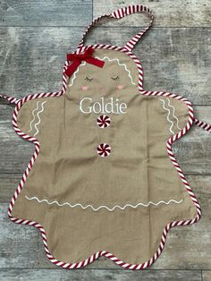 an apron with the name goldie on it and candy canes hanging from it