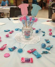 a table topped with candy and candies on top of a blue table cloth covered table