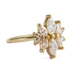 a yellow gold ring with three pear shaped diamonds