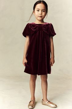 H&M Adorables. A-line dress in soft velvet made from a silk blend with a natural sheen and a smooth feel. Round neckline and a large  decorative bow and pleat on the front. Keyhole opening with a button at the back and short puff sleeves. Lined. The H&M Adorables collection is a curated selection of high-comfort  quality pieces with a timeless appeal. Burgundy Tights, Active Swimwear, Sportswear Trends, Kids Outerwear, Maternity Wear, Newborn Outfits, Outdoor Apparel, Soft Velvet, Holiday Dresses