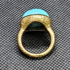 14k solid hammered yellow gold ring with 13.5 ct. 16.5 mm round shape natural spider turquoise. This item can also be ordered in rose or white gold with different color gemstones such as, green tourmaline, pink tourmaline, rutilated quartz, onyx, labradorite, white agate, all colors of chalcedony and aquamarine, please contact for a quote as each gemstone varies in price. I am a manufacturer of fine jewelry for over thirty years, loyalty & customer satisfaction has always been my ultimate go Unique Yellow Gold Oval Turquoise Ring, Handmade Yellow Gold Turquoise Ring, Handmade Turquoise Ring In Yellow Gold, Artisan Gold Turquoise Ring, Hammered Ring, Hammered Rings, White Agate, Swiss Blue Topaz, Blue Band