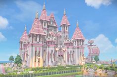 a large pink castle sitting on top of a lush green field