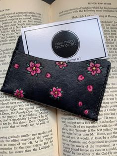 A handmade, hand painted, hand dyed leather card wallet that can hold up to 5 cards. Vegetable tanned leather dyed Black with a hand painted cherry blossoms and petals with black waxed thread stitching. Black Handmade Card Holder For Daily Use, Leather Journal Cover, Leather Bookmark, Leather Card Wallet, Leather Dye, Black Leather Wallet, Mini Canvas Art, Mini Canvas, Money Clip Wallet