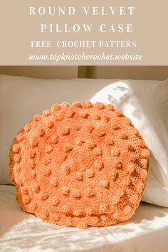 an orange crocheted round pillow sitting on top of a bed with the words round velvet pillow case free crochet pattern