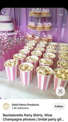 pink and white striped paper cups filled with popcorn