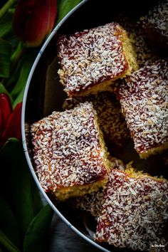 several pieces of cake sitting in a metal pan