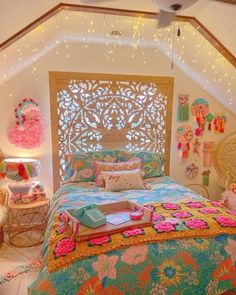 a room with a bed, wicker chairs and lights on the ceiling is decorated in pastel colors