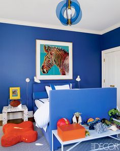 a bedroom with blue walls and white furniture