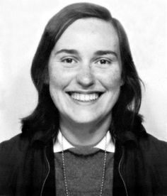 a black and white photo of a woman smiling