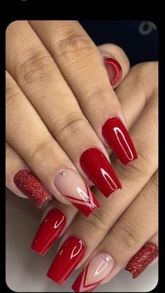 a woman with red and pink nail polish on her nails