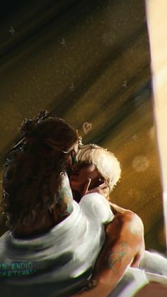 a man and woman embracing each other in front of a window with the sun shining on them