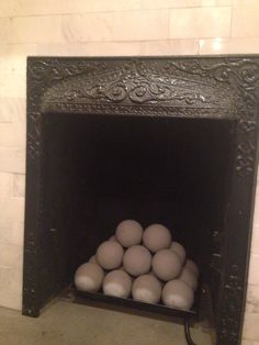 a fire place with some balls in it