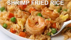 shrimp fried rice with peas and carrots on a white plate