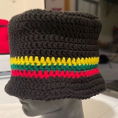 Crotchet Hat. Black W/(Red Green Gold/Yellow). Handmade. New. Acrylic. Stretchy. Unisex. One Size Fits Most. New Without Tags. White Hat Sold Separately. Black Knitted Beanie In Acrylic Yarn, Black Acrylic Yarn Beanie One Size, Black Acrylic Yarn Beanie Cap, Black Cotton Knitted Beanie, One Size Black Acrylic Yarn Beanie, Black Acrylic Yarn Beanie, Casual Black Crochet Hat For Winter, Black Crochet Beanie Hat, Black One Size Beanie From Acrylic Yarn