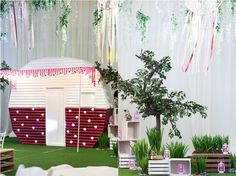 an outdoor stage set up for a party with decorations and trees on the sidelines