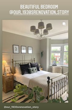 a white bed sitting next to a window with two lamps on either side of it