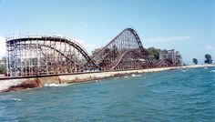 an amusement park roller coaster in the water