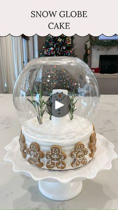 the snow globe cake is decorated with gingerbreads