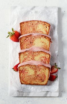 three slices of strawberry bread with icing and strawberries