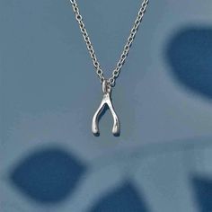 A gift for family and friends who might be a bit down on their luck. This little wishbone charm channels good vibes, and may be just the thing to turn bad luck to good! This tiny charm necklace comes on a sterling silver 18 inch chain with a spring ring clasp. The charm measures 7x5mm, excluding jumprings. Moon Energy, Wishbone Necklace, Neck Ring, Tiny Charm, Wire Necklace, Bad Luck, Silver Moon, Dream Jewelry, Jewelry Inspo