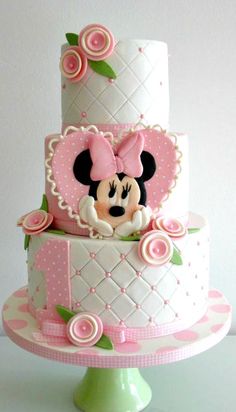 a three tiered cake with minnie mouse on top