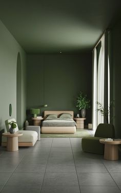 a bedroom with green walls and furniture in the corner, along with large glass windows