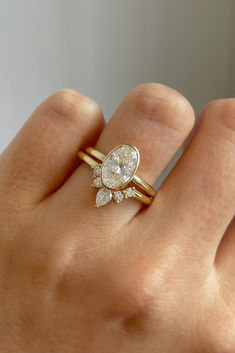 a woman's hand with a ring on it and a diamond in the middle