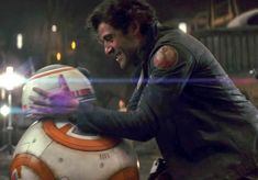 a man is riding on top of a star wars bb - 8