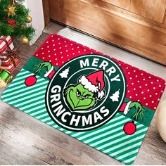 a door mat with the grin face on it and merry grinmas written in green