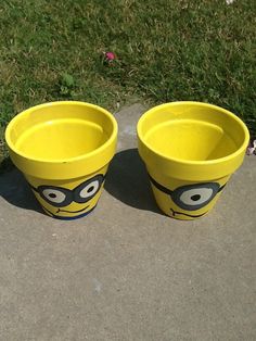 two yellow plastic cups with faces painted on them