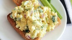 an egg salad on toast with asparagus on the side