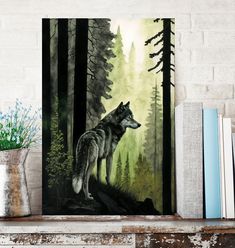 a painting of a wolf standing in the woods on a shelf next to books and flowers