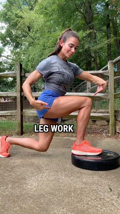 a woman is doing squats on a tire in front of a fence with the caption leg work