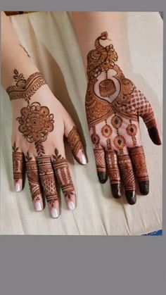 two hands with henna tattoos on them