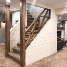 a living room filled with furniture and a stair case