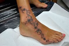 a woman with a tattoo on her foot